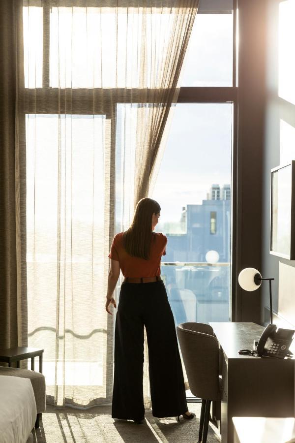 The Mayfair クライストチャーチ エクステリア 写真 A woman opening a curtain